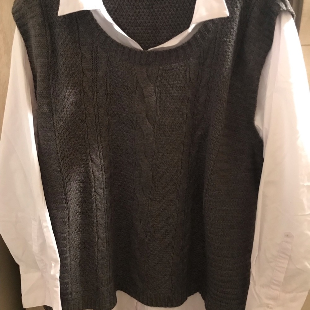 Grey sweater vest with white sleeves and collar